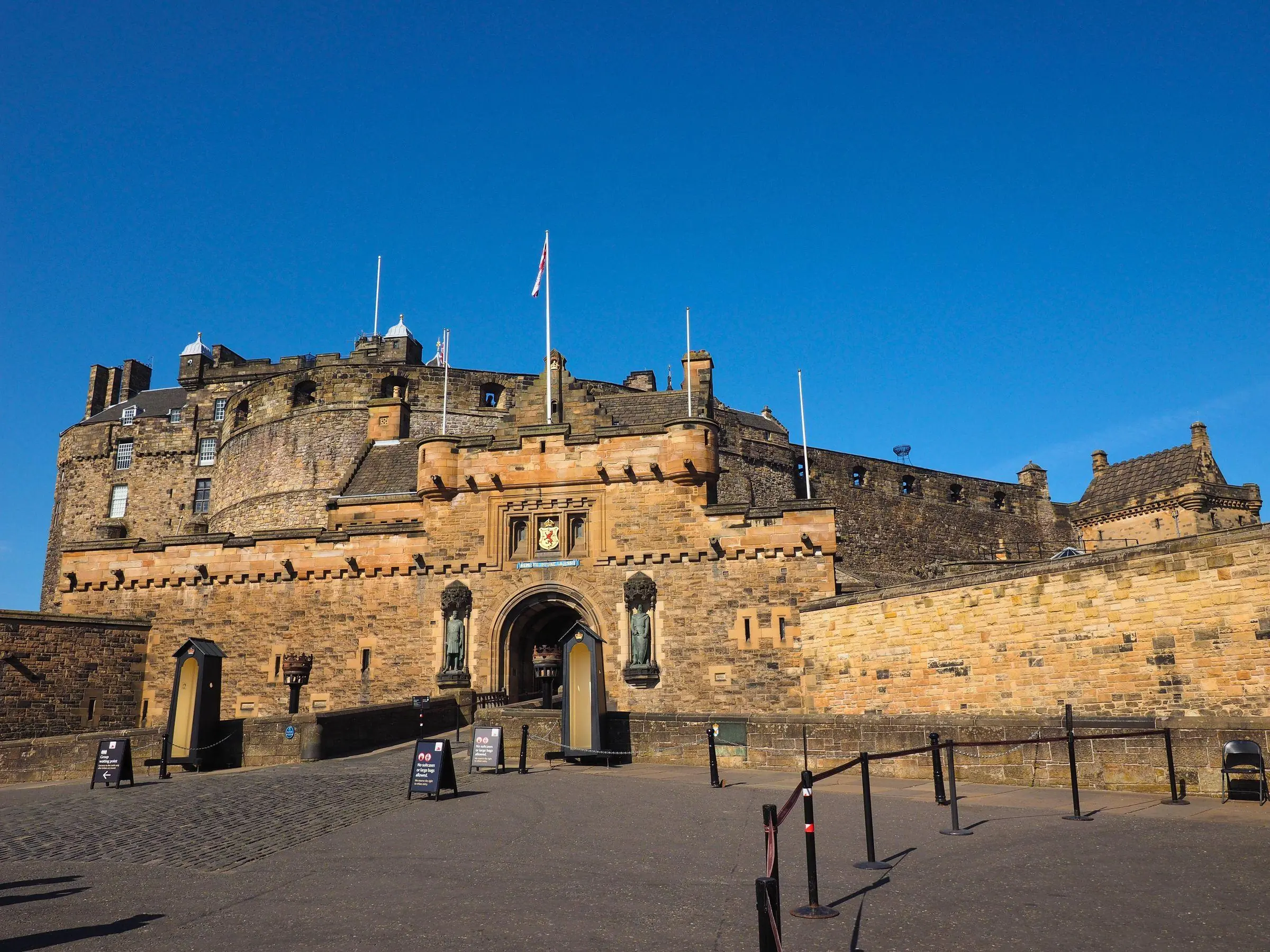Edinburgh Castle sitting atop Castle Rock against a cloudy sky